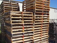 Stacks of recycled 4 way stringer pallets